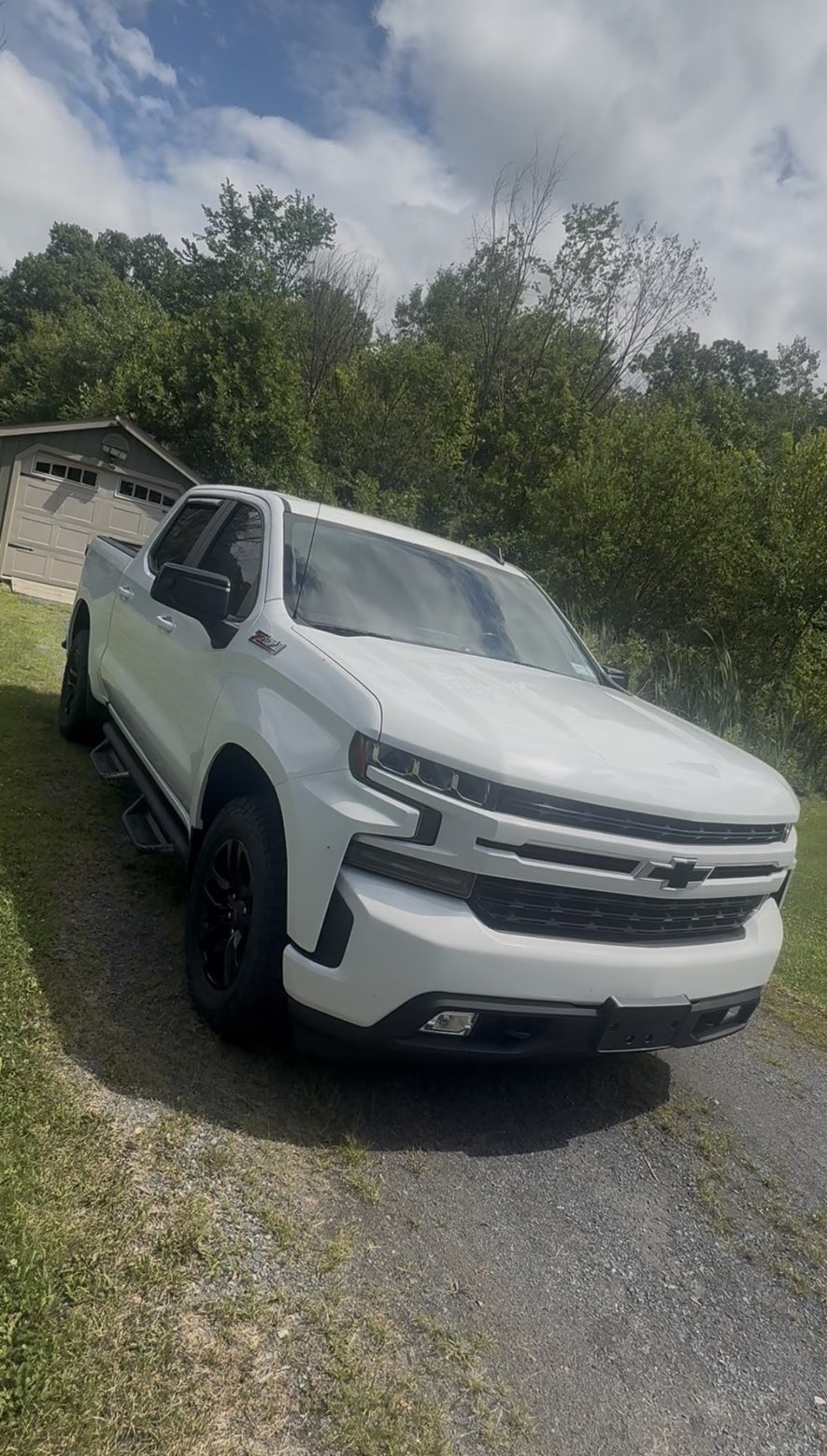 Freshly detailed white Chevrolet Silverado with a glossy finish